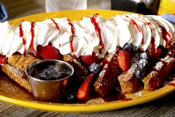 Fresh Blackberries, Strawberries, and Blueberries. Topped with Whipped cream, Raspberry sauce, Cinnamon, and Powdered Sugar.